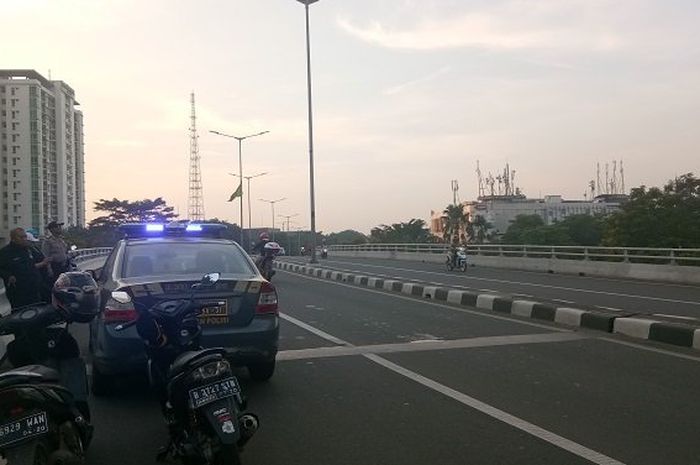 Petugas berjaga-jaga di tepi jalan fly over Kalibata, Jakarta Selatan, Minggu (27052018). Mereka mengusir pengendara motor yang ingin adu balap liar