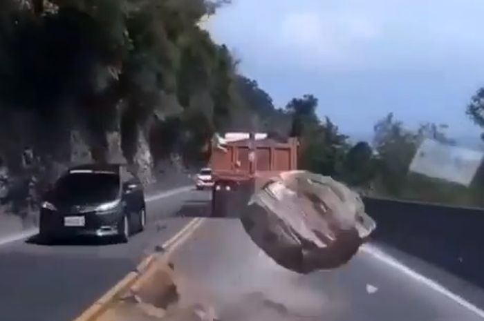 Batu gunung jatuh persis di depan mobil