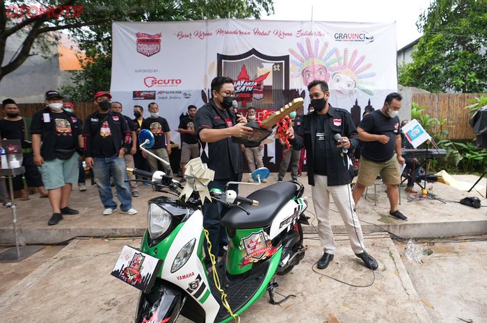 Asep Maulana Mardiat alias Jolay (kiri) ketua GRAVINCI chapter Jakarta Satu berikan kunci simbolis Yamaha Fino kepada member yang beruntung