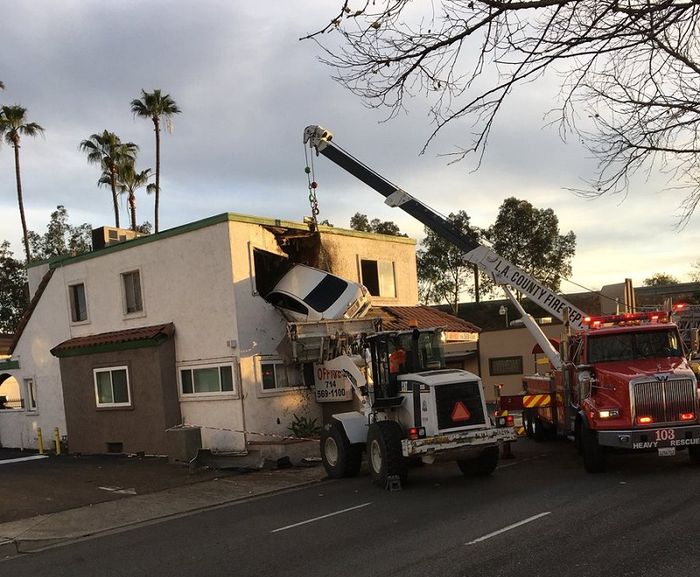 Proses evakuasi mobil yang menancap pada sebuah gedung