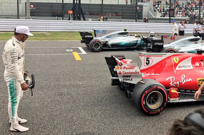 Lewis Hamilton mengamati mobil F1 Ferrari besutan Sebastian Vettel di GP F1 Jepang 2017 lalu