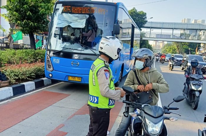 Ilistrasi Pengendara lewat jalur transjakarta di Jakarta Pusat