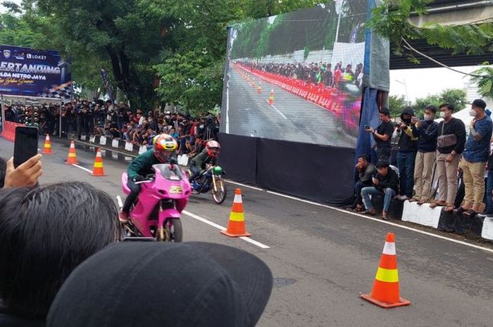 Para joki saat melakukan balapan dalam ajang street race di Ancol, Jakarta Utara, Minggu (16/1/2022).