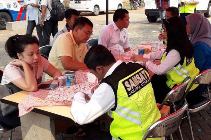 Sejumlah pelanggar razia pajak di Penjaringan mengurus pembayaran pajak di hadapan petugas Samsat Jakarta Utara, (21/11/2018)