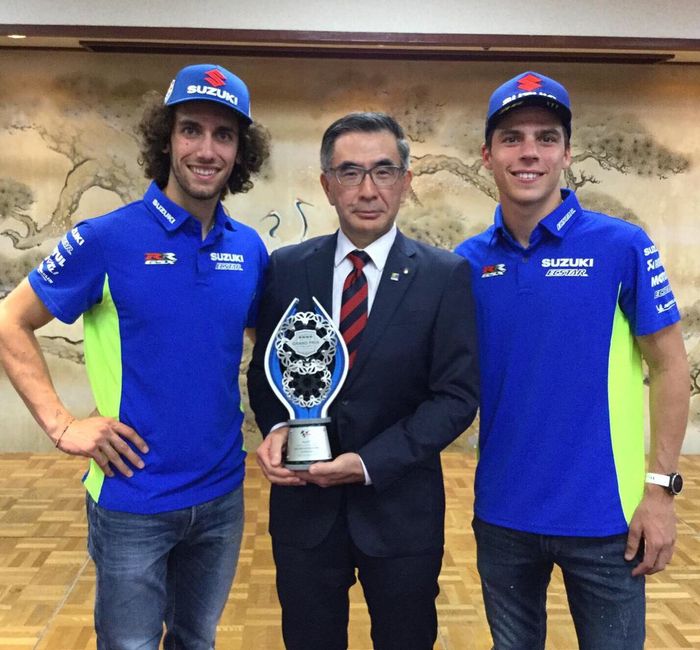 Presiden Suzuki Motor Corporation, Toshihiro Suzuki memegang trofi saat Alex Rins memenangkan MotoGP Inggris