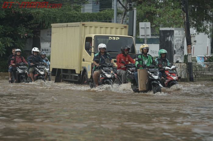 Pemotor menerjang banjir di Green Garden, Kedoya, Jakarta Barat. Begini teknik pengereman yang benar saat melewati banjir
