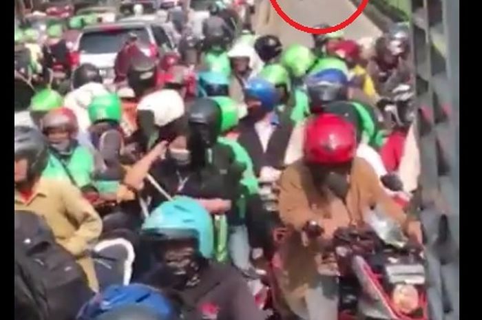 Di depan jalur Transjakarta Polisi (lingkaran merah) belakang bus Transjakarta