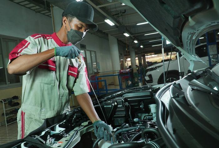 Ilustrasi pengecekal oli mesin lewat dipstick di Auto2000