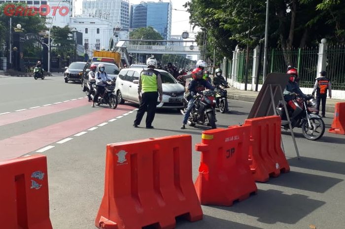 Polisi bersama Dishub melakukan penyekatan di arah masuk Jalan Medan Merdeka Utara