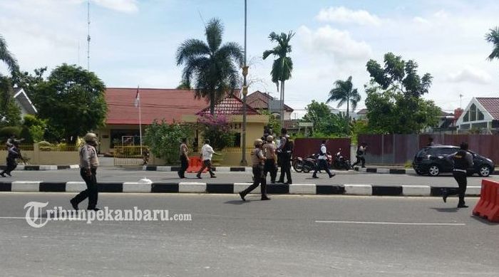 Polisi bersenjata lengkap memburu pelaku penyerangan Polda Riau, Rabu (16/5/2018) 