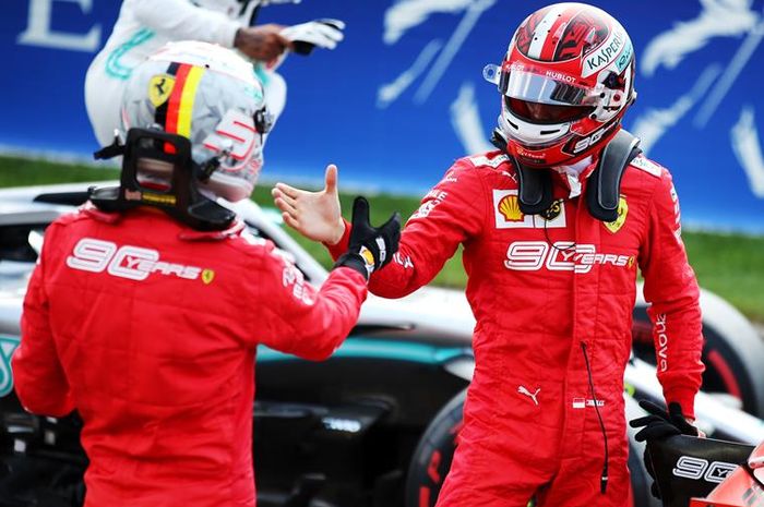 Pembalap Ferrari, Sebastian Vettel (kiri) ikut senang dengan kemenangan yang diraih rekan setimnya, Charles Leclerc (kanan) di F1 Belgia 2019
