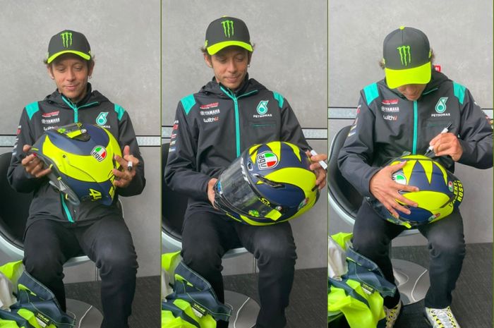 Valentino Rossi menanda tangani hel replika AGV untuk menggalang dana