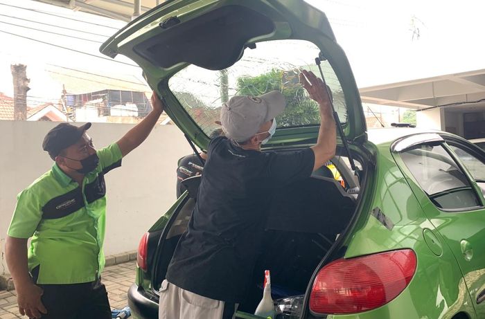 Proses pemasangan kaca film Miracle pada mobil konsumen di outlet BSD