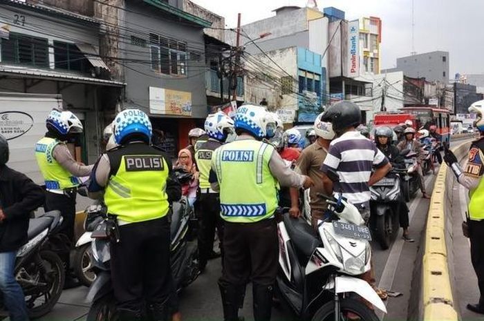 Ilustrasi penilangan pengendara motor yang nekat menerobos jalur transjakarta