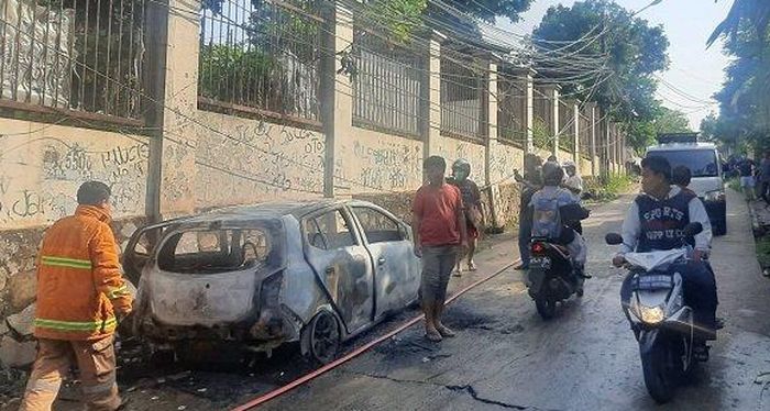Para petugas Damkar kota Depok berhasil memadamkan api yang membakar Daihatsu Ayla di Tanah Baru, Beji, kota Depok