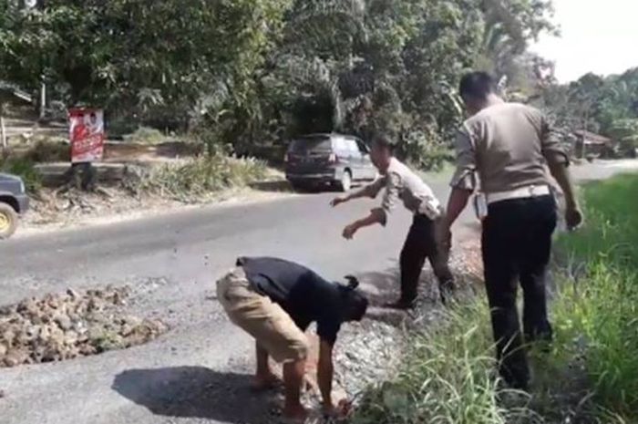 otongan video yang diunggah pengguna Facebook Aconk Asfiyek mengenai polisi yang menambal jalan berlubang di Paser, Kalimantan Timur