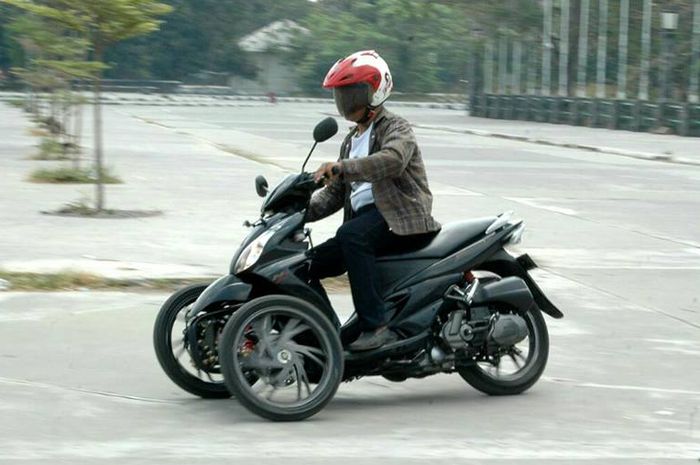 Rubiyanto dengan salah satu motor trike bikinan bengkelnya