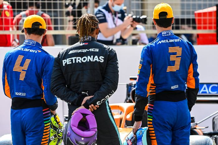 Lewis Hamilton bersama dua pembalap tim McLaren, mengamati mobil McLaren bermesin Mercedes pada tes pramusim F1 2021 di Bahrain