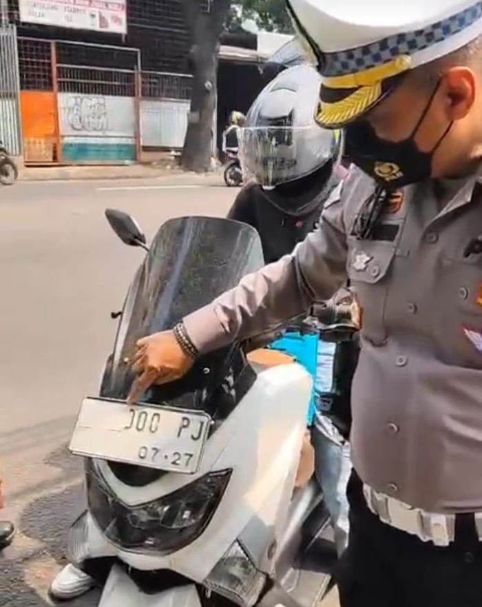 Pelat nomor ditempel lakban putih untuk hindari tilang elektronik