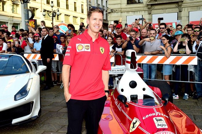 Sebastian Vettel berpose di mobil F1 Ferrari yang pernah dipakai Niki Lauda juara dunia
