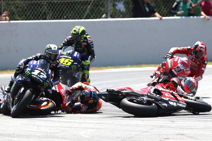 Andrea Dovizioso (kanan) jatuh setelah diseruduk Jorge Lorenzo (kiri, jatuh) di lap kedua MotoGP Catalunya