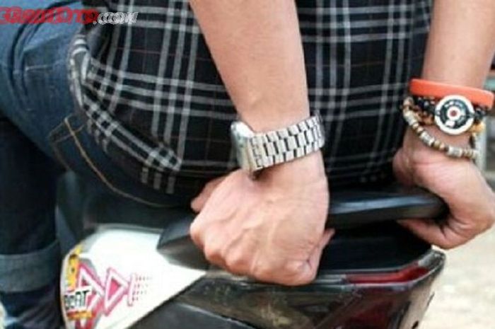 Ilustrasi. Boncengers berpegangan pada behel motor